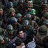 Egyptian protesters push army soldiers standing guard in front of the presidential palace in Cairo, Dec. 9, 2012.