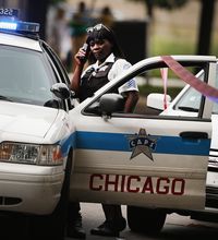 Chicago police investigate the shooting death of 14-year-old Tommy McNeal on Sept. 20, 2013. McNeal was one of at least three killed and about 30 wounded by gunfire in the city within 24 hours.
