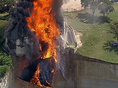 Raw: Fire Crews Burn House on Texas Cliff