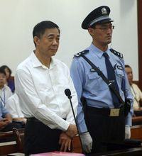 In this Aug. 22, 2013, photo released by the Jinan Intermediate People's Court, former Politburo member and Chongqing city party leader Bo Xilai, center, stands on trial at the court in eastern China's Shandong province.