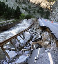 A guardrail hangs away from a closed canyon road, which links Boulder with the mountain town of Nederland, and which is washed out in places by recent flooding, up Boulder Canyon, west of Boulder, Colo.
