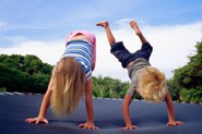 Two kids playing on trampoline