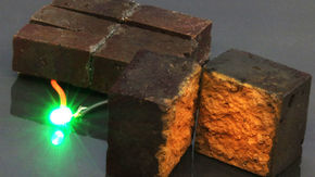 a red brick device lights up a green light-emitting diode